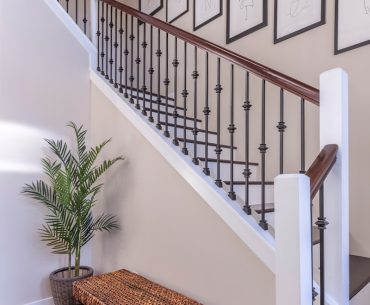 brown wooden bench near white stair