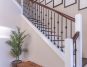 brown wooden bench near white stair